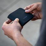 Wayfinder DAYBREAKER modern minimal billfold wallet over the shoulder in hand view