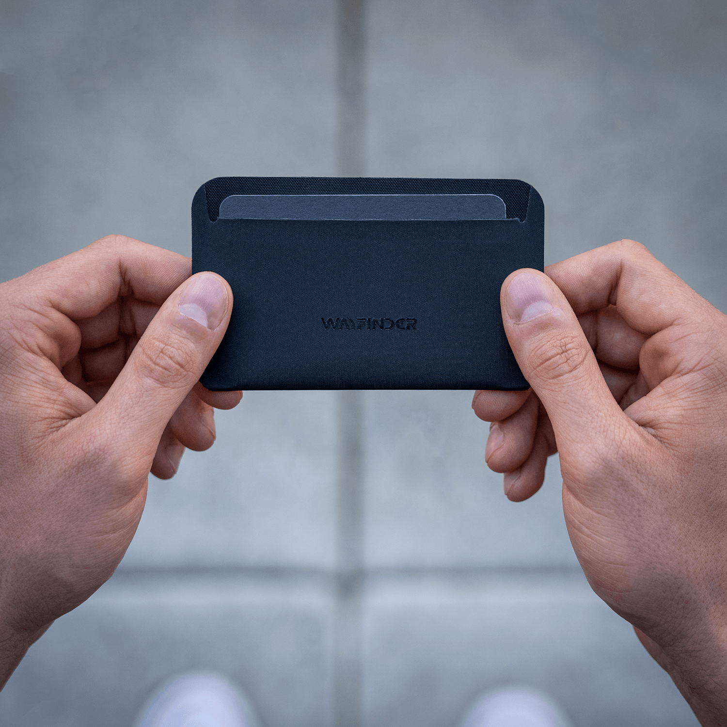 Wayfinder FLUX modern minimal cardholder top view held in hands